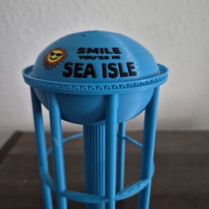 Bring home the Jersey Shore with this 7.5" 3D printed “Smile, You’re in Sea Isle” water tower replica. A bright and iconic Sea Isle City landmark, perfect for décor, gifts, and beach lovers. Made in the USA.