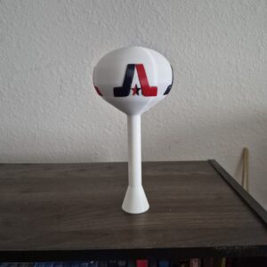 3D printed miniature replica of the Arlington, Texas water tower featuring a white spheroid tank with red, white, and blue Arlington “A” logo mounted on a white pedestal base.