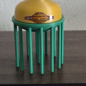 3D printed replica of the West Tampa, Florida water tower with green supports, yellow tank, and English and Spanish welcome decals.