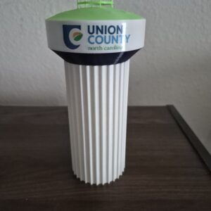3D printed replica of the Union County, North Carolina water tower with green top, white pillar base, and county logo.