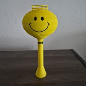 3D printed Ashley, Indiana Smiley Face Water Tower replica with yellow tank, black smiley face, and bowtie.