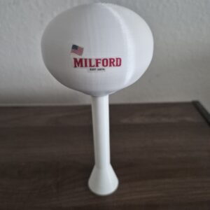 3D printed Milford Illinois water tower replica with white spheroid tank, American flag graphic, and elevated pedestal support.