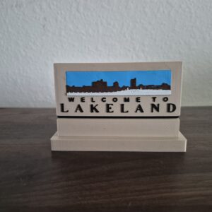 3D printed Welcome to Lakeland roadside sign replica featuring the Downtown Lakeland skyline and welcome message.
