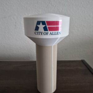 3D printed Allen Texas water tower replica with City of Allen logo, white elevated tank, and beige pedestal support.