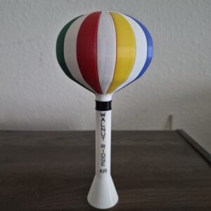 replica of the Walnut Ridge, Arkansas water tower featuring a colorful balloon-inspired design with vertical "Walnut Ridge AR" lettering.