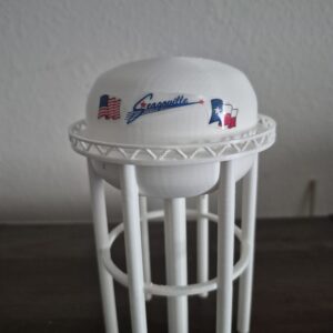 3D printed Seagoville, Texas water tower replica with white elevated tank, multi-column support structure, and Seagoville logo featuring the American and Texas flags.