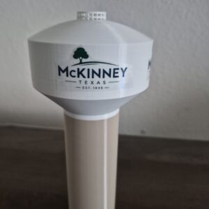 replica of the McKinney, Texas water tower featuring a stylized interpretation of the city's branding.